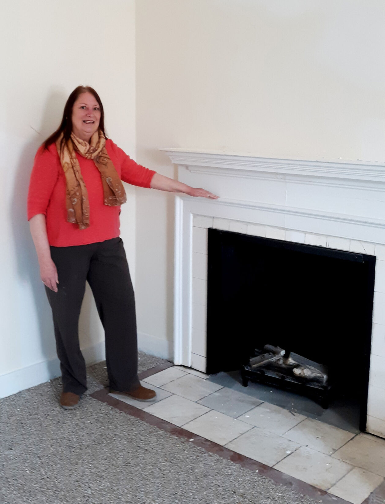 Linda Mead with fireplace.jpg